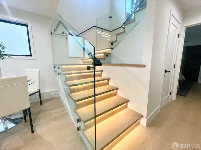 stairway with hardwood / wood-style flooring