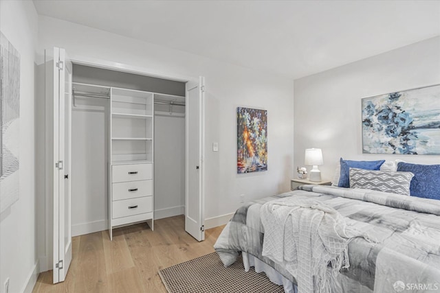 bedroom featuring light wood-type flooring and a closet