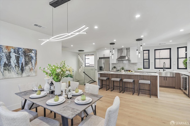 dining area with sink and light hardwood / wood-style floors