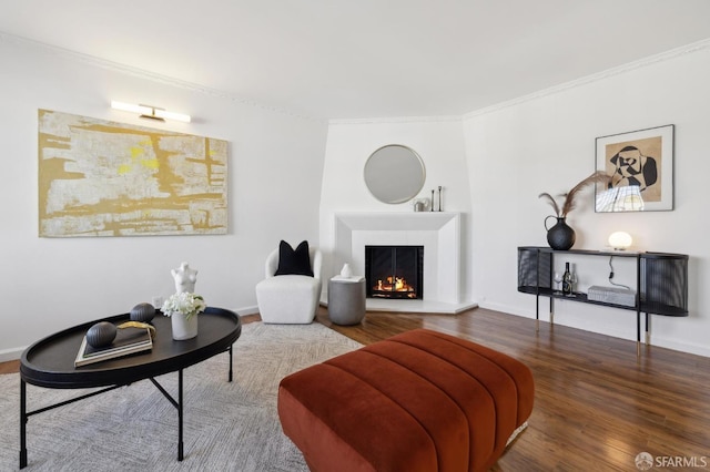 living room featuring wood-type flooring and ornamental molding