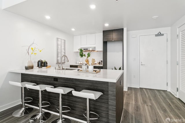 1688 Pine St Unit E709, San Francisco, CA 94109 - kitchen featuring a sink, a breakfast bar, dark wood-style floors, light countertops, and modern cabinets