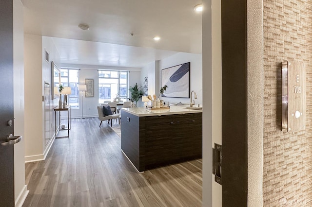 1688 Pine St Unit E709, San Francisco, CA 94109 - kitchen with a sink, wood finished floors, light countertops, dark brown cabinetry, and baseboards