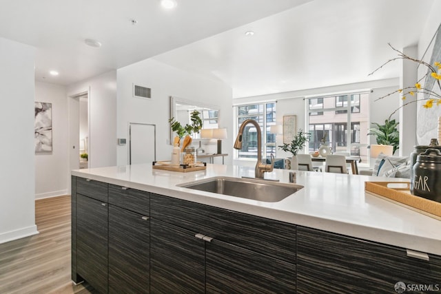 1688 Pine St Unit E709, San Francisco, CA 94109 - kitchen featuring a sink, light wood-style floors, light countertops, open floor plan, and baseboards