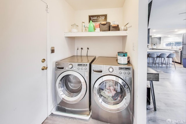 laundry room featuring laundry area, separate washer and dryer, and wood finished floors