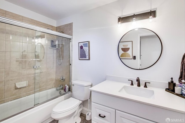 bathroom featuring vanity, toilet, and bath / shower combo with glass door