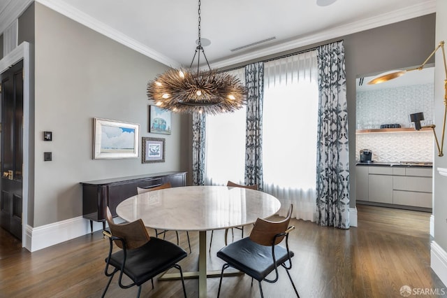 dining room with ornamental molding and dark hardwood / wood-style floors