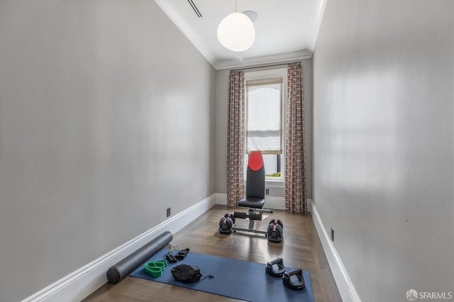 exercise room featuring wood-type flooring and ornamental molding