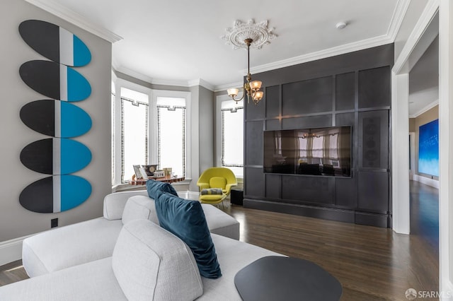 living room featuring a chandelier, dark wood-type flooring, and crown molding