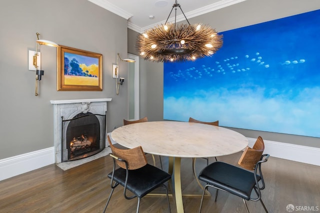 dining room with ornamental molding, dark hardwood / wood-style floors, and a high end fireplace