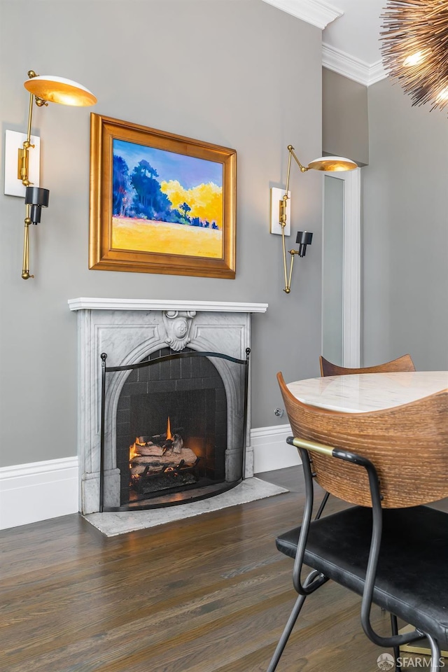 dining area featuring ornamental molding and dark hardwood / wood-style floors