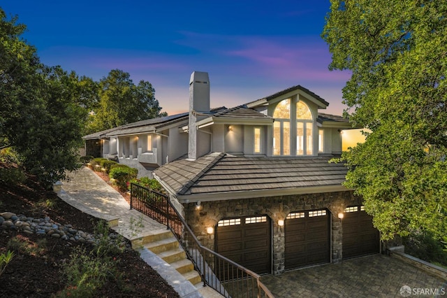 12553 Parker Ranch Ct, Saratoga, CA 95070 - view of front of house featuring a chimney, stone siding, a garage, stairway, and stucco siding