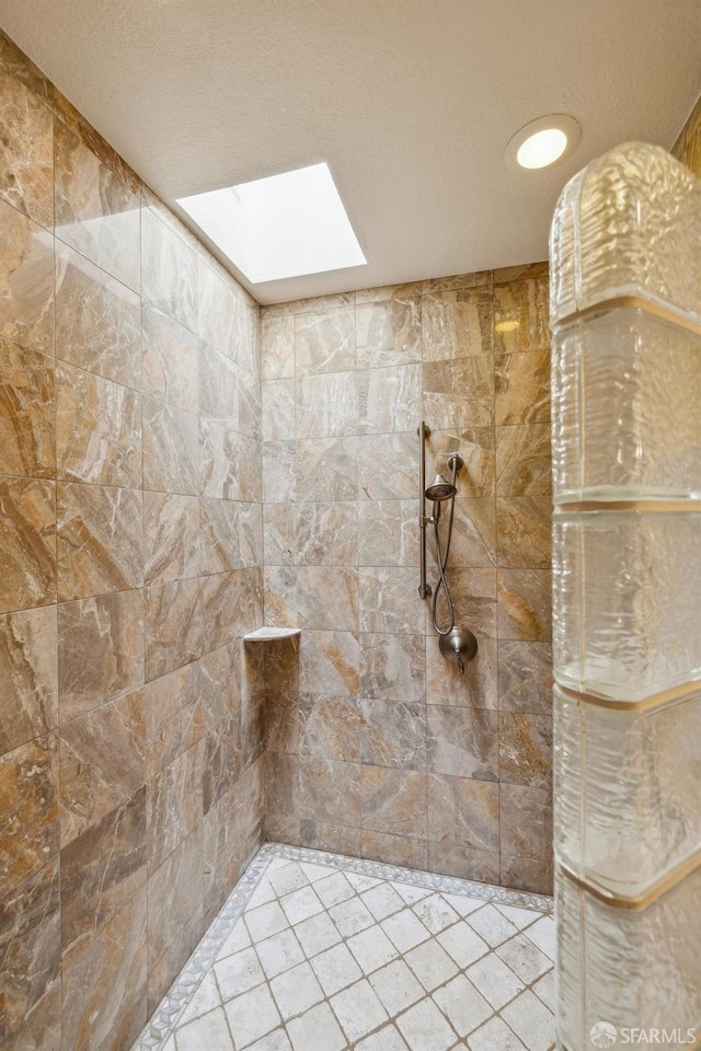 12553 Parker Ranch Ct, Saratoga, CA 95070 - bathroom featuring tiled shower, a skylight, and tile patterned floors