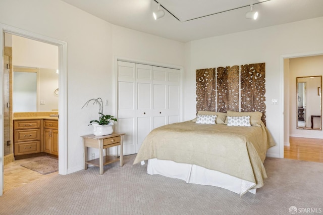 12553 Parker Ranch Ct, Saratoga, CA 95070 - bedroom with rail lighting, light carpet, a closet, ensuite bath, and baseboards