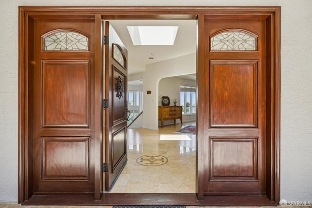 12553 Parker Ranch Ct, Saratoga, CA 95070 - foyer featuring a skylight, tile patterned floors, arched walkways, and a textured wall
