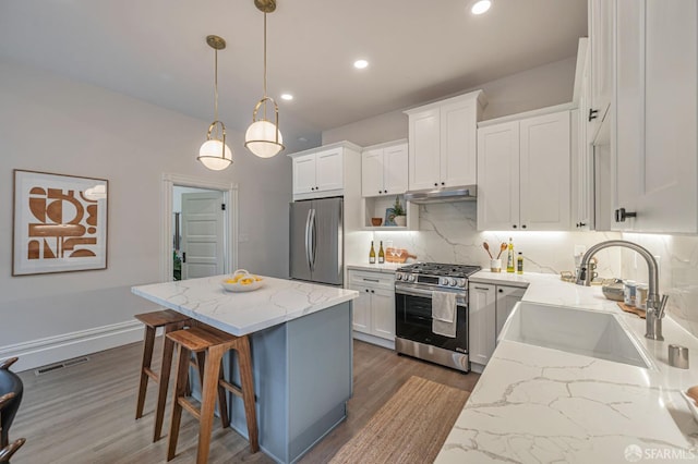 278 Whitney St, San Francisco, CA 94131 - kitchen featuring stainless steel appliances, dark wood-type flooring, a center island, decorative backsplash, and white cabinetry