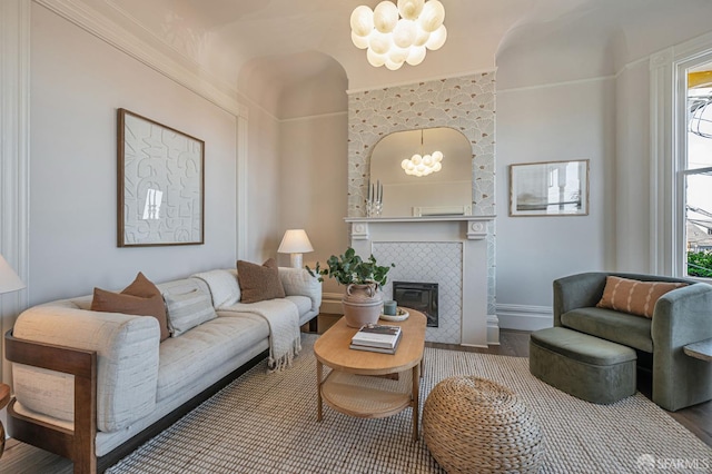 278 Whitney St, San Francisco, CA 94131 - living area with wood finished floors, a chandelier, a fireplace, and ornamental molding