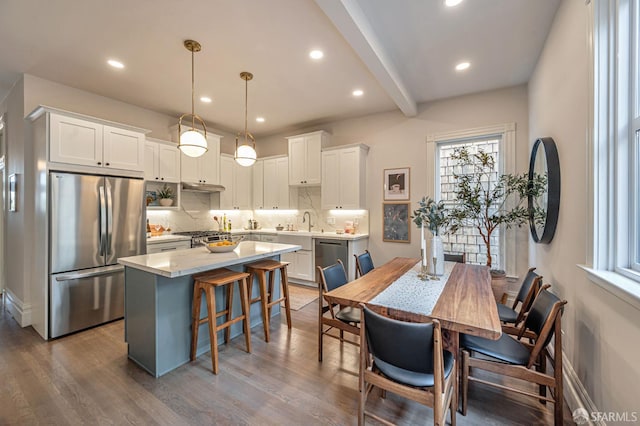 278 Whitney St, San Francisco, CA 94131 - kitchen featuring stainless steel appliances, tasteful backsplash, a center island, light countertops, and white cabinetry