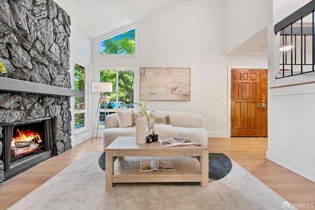 1945 Las Encinas Ct, Los Gatos, CA 95032 - living room with high vaulted ceiling, a stone fireplace, wood finished floors, and stairway
