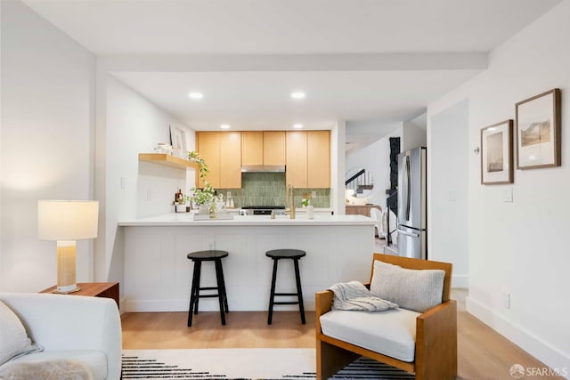 1945 Las Encinas Ct, Los Gatos, CA 95032 - kitchen with freestanding refrigerator, backsplash, a peninsula, a kitchen breakfast bar, and light brown cabinetry