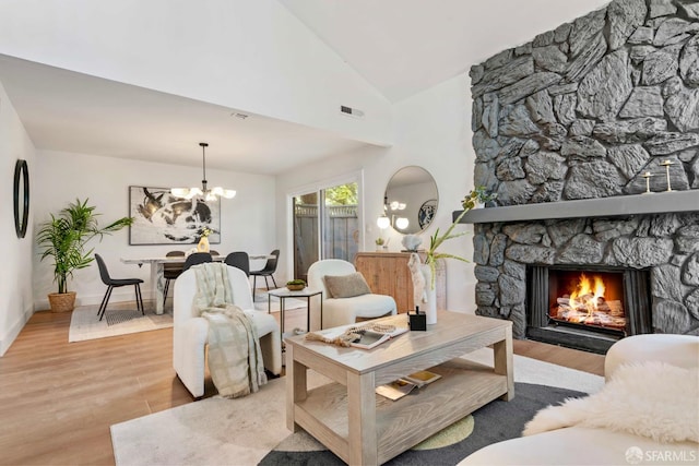 1945 Las Encinas Ct, Los Gatos, CA 95032 - living area with wood finished floors, a chandelier, a stone fireplace, and vaulted ceiling