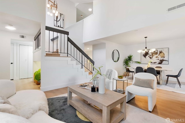 1945 Las Encinas Ct, Los Gatos, CA 95032 - living area featuring a chandelier, stairway, wood finished floors, and a towering ceiling