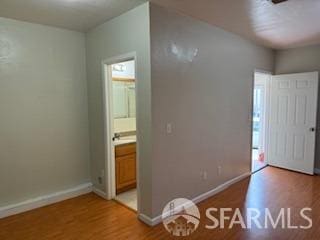 3328 San Jose Ave, Daly City, CA 94014 - unfurnished bedroom with baseboards, light wood finished floors, and ensuite bath