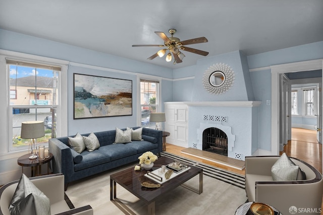 3328 San Jose Ave, Daly City, CA 94014 - living area with a tiled fireplace, a ceiling fan, wood finished floors, and a wealth of natural light