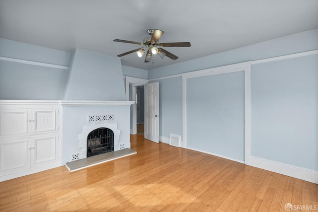 3328 San Jose Ave, Daly City, CA 94014 - unfurnished living room featuring a ceiling fan, visible vents, wood finished floors, a tile fireplace, and baseboards