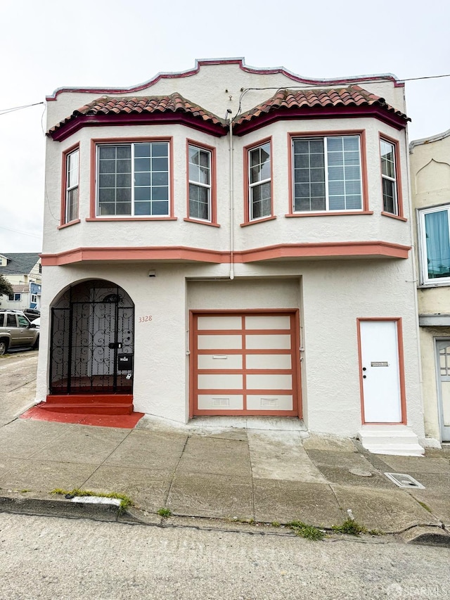 3328 San Jose Ave, Daly City, CA 94014 - view of front of home with a tiled roof, an attached garage, and stucco siding