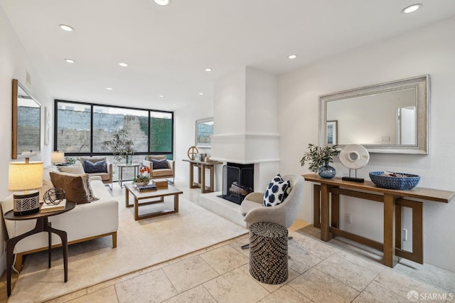 living room with floor to ceiling windows and a fireplace