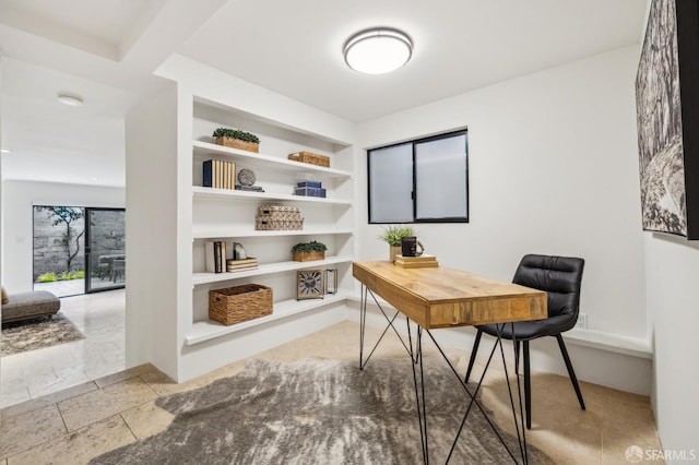 home office featuring built in shelves