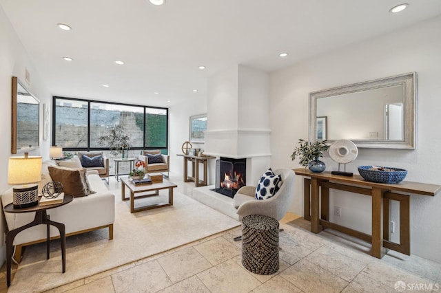 living room with expansive windows and a multi sided fireplace