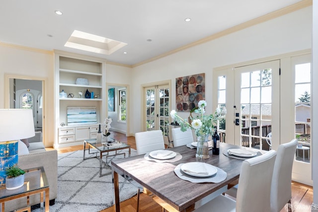 153 Dale Ave, San Carlos, CA 94070 - dining area with a skylight, ornamental molding, healthy amount of natural light, light wood-style flooring, and built in shelves