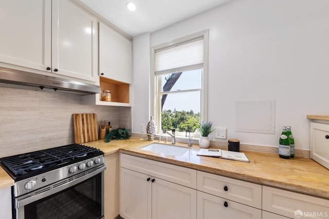 153 Dale Ave, San Carlos, CA 94070 - kitchen with stainless steel gas range, under cabinet range hood, white cabinetry, backsplash, and recessed lighting