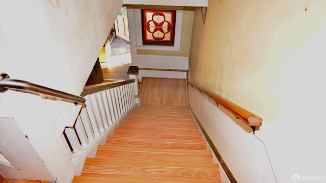 stairs featuring hardwood / wood-style flooring