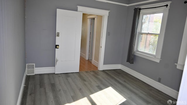 empty room with hardwood / wood-style floors