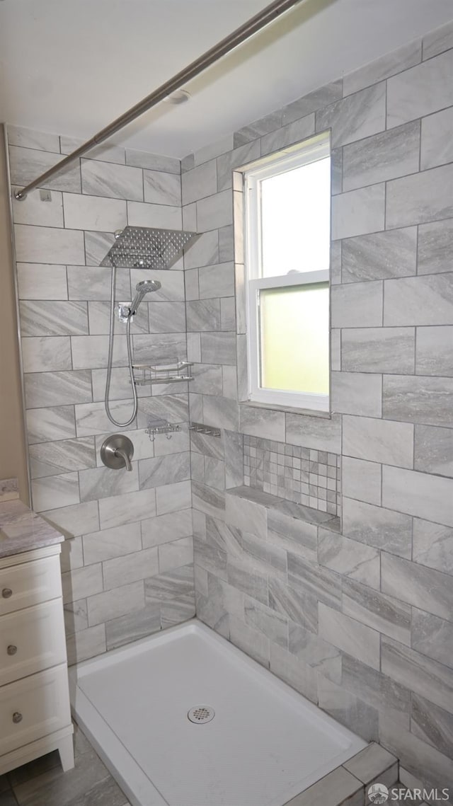 bathroom with tiled shower