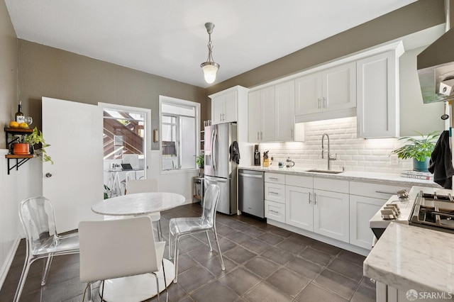 243 Henry St Unit A, San Francisco, CA 94114 - kitchen with appliances with stainless steel finishes, decorative backsplash, wall chimney exhaust hood, white cabinets, and light stone counters
