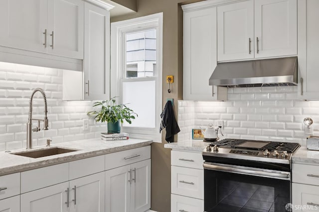 243 Henry St Unit A, San Francisco, CA 94114 - kitchen featuring stainless steel gas range oven, extractor fan, tasteful backsplash, white cabinetry, and light stone countertops