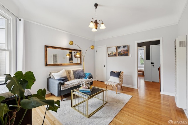 243 Henry St Unit A, San Francisco, CA 94114 - living room with a heating unit, a chandelier, light wood-style flooring, and crown molding