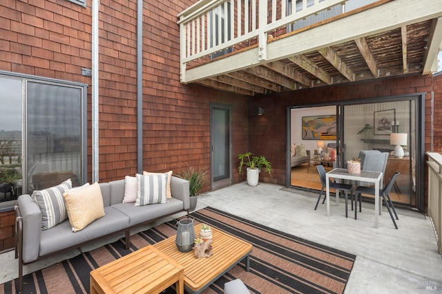 view of patio / terrace with a balcony, an outdoor hangout area, and outdoor dining area