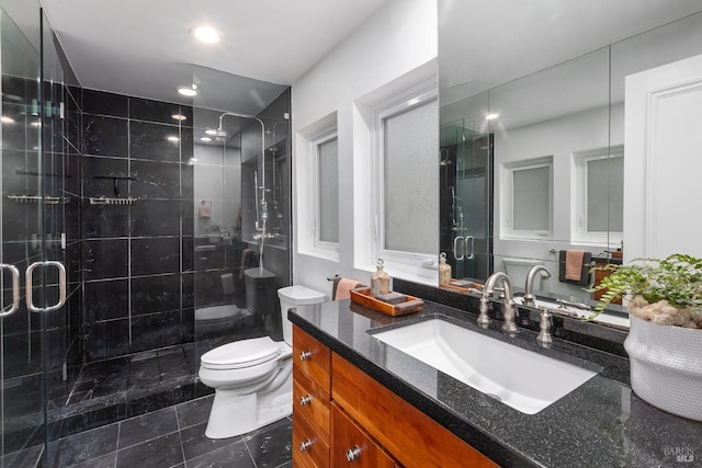 bathroom with toilet, a stall shower, tile patterned flooring, and vanity