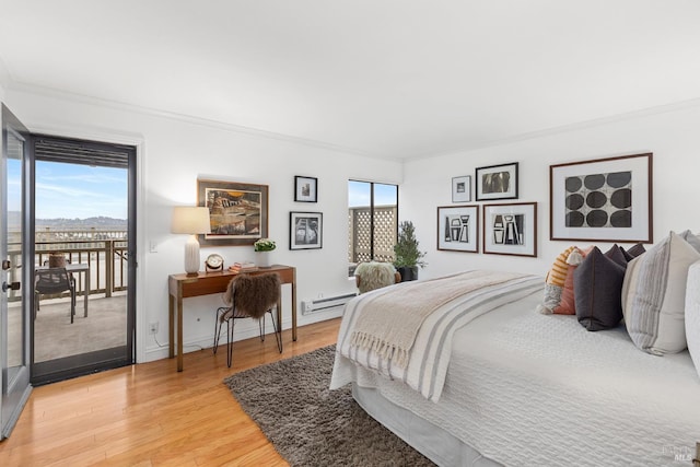 bedroom with a baseboard radiator, access to exterior, ornamental molding, light wood finished floors, and baseboards