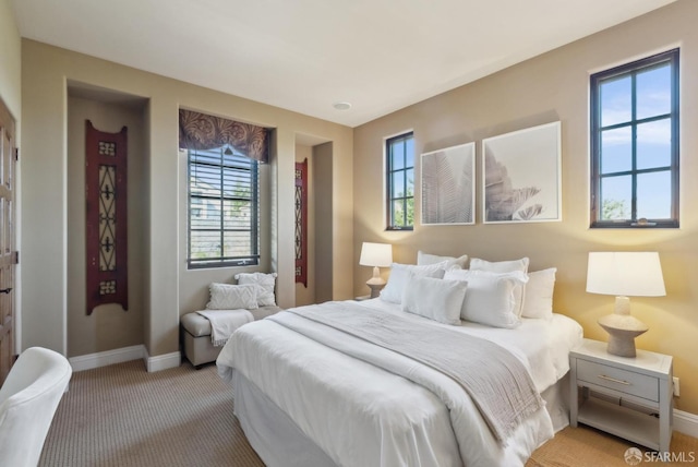 bedroom featuring carpet flooring and baseboards