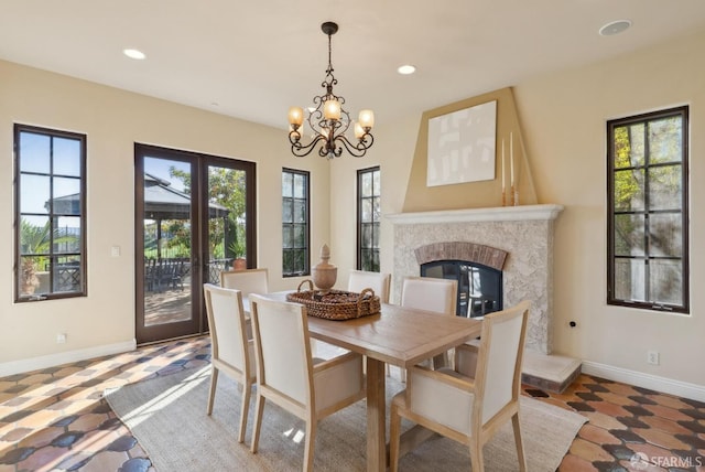 dining area with a notable chandelier, recessed lighting, a fireplace, and baseboards