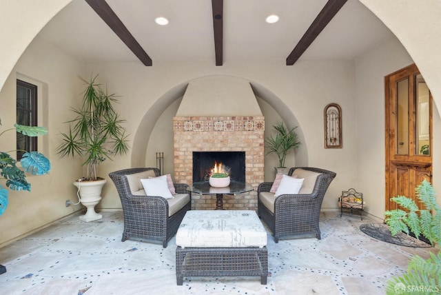 view of patio with an outdoor living space with a fireplace