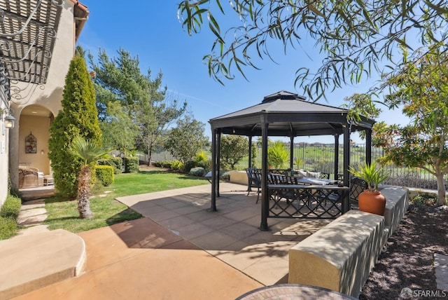 view of patio featuring a gazebo and fence