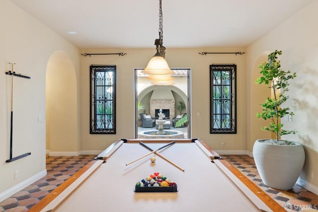 playroom with arched walkways, pool table, and baseboards