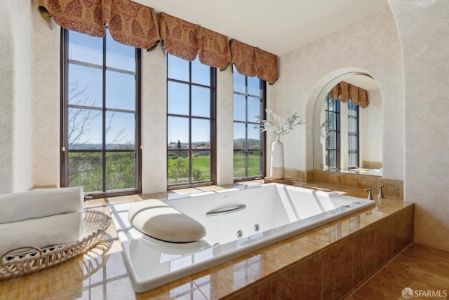 full bathroom with a jetted tub