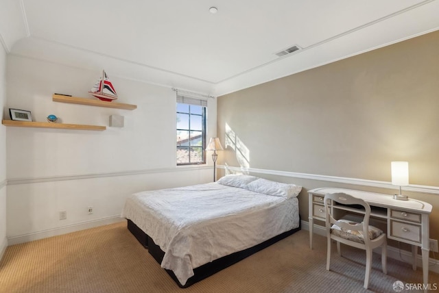 carpeted bedroom with visible vents and baseboards